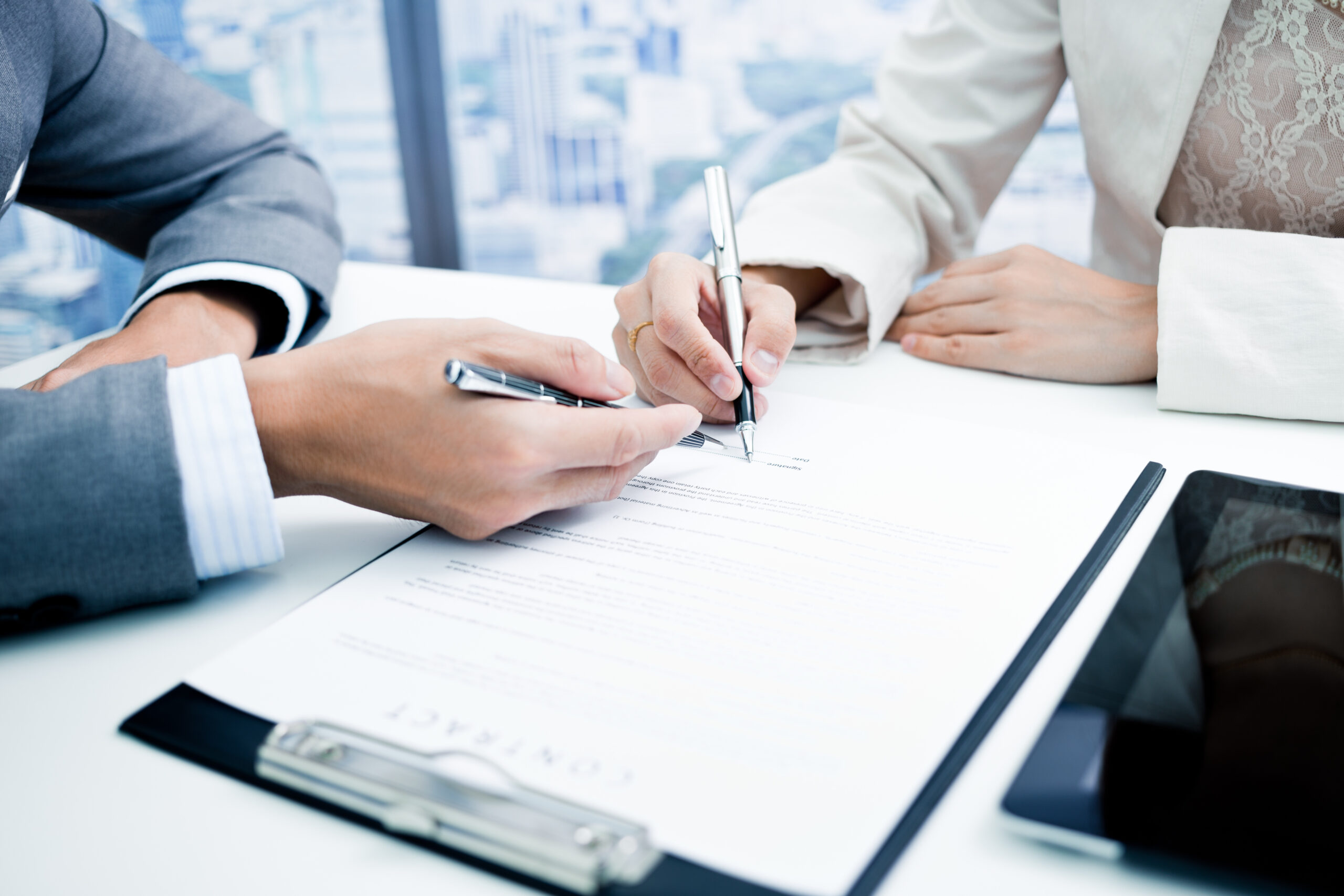 Female hand signing contract.